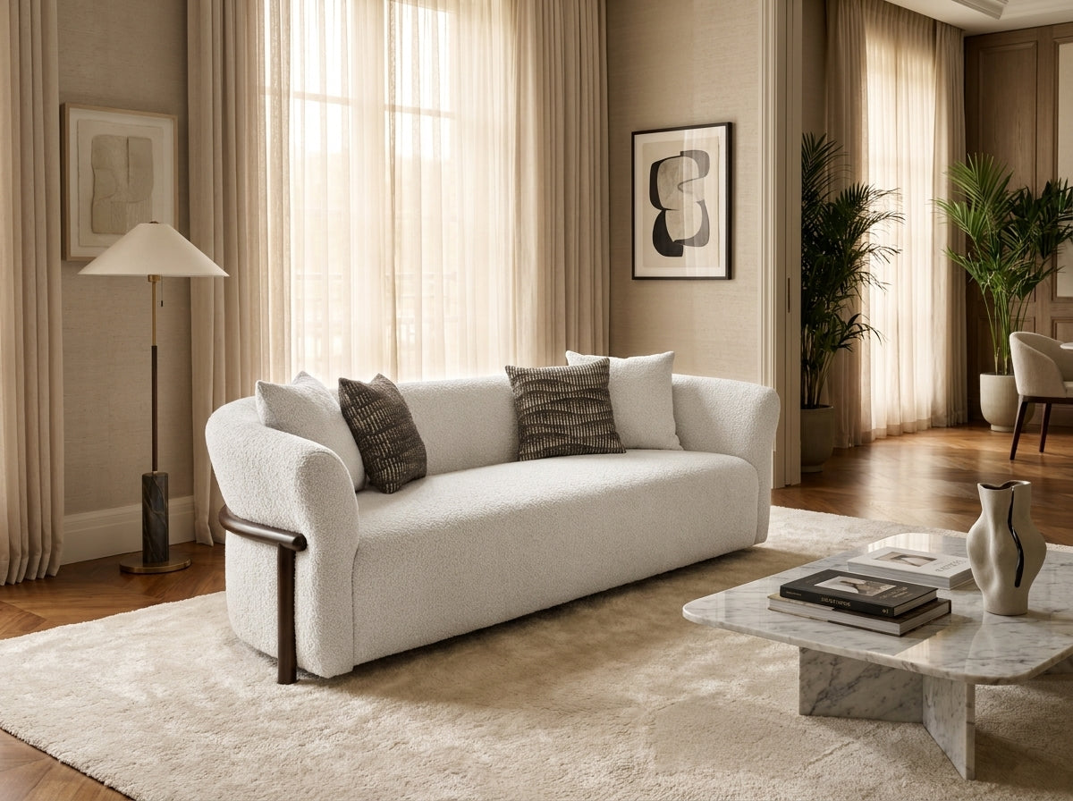 Talia Modern 3 Seater Fabric Sofa in White with curved bouclé upholstery and timber leg detail, styled in a living room – Quality Rugs & Furniture Dandenong and Hoppers Crossing